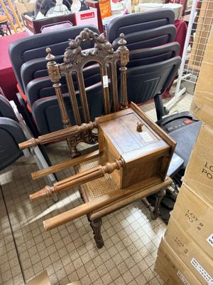 a chair that is sitting in front of a stack of chairs