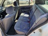 the interior of a car with a blue seat cover and a black seat belt