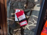 a camouflage pants hanging on a clothes rack in a store