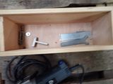 a small box with a drill and a tool inside of it