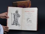 une personne tenant un livre ouvert sur lequel figure un dessin
