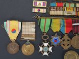 several medals and medals are displayed on a black surface