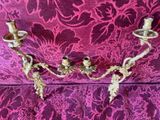 two candles that are sitting on a purple cloth