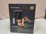 packaging of a black and silver air fryer sitting on a white surface