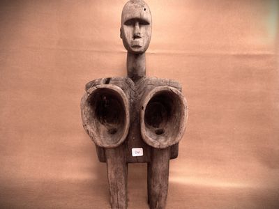 a sculpture of a man with two horns on a wall
