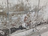 an image of a clothes rack in front of a brick wall