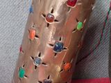 un vase et une cuillère posés sur une table recouverte d'une nappe rouge