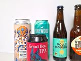 several different types of beer are lined up on a table