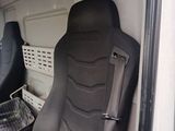 a seat in the back of a van with a basket in it