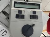 a clock on top of a stack of boxes with price tags on it
