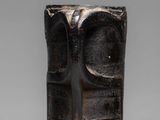 a close up of a vase with a face on it