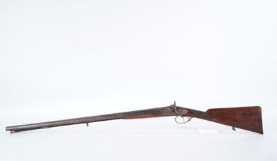 a rifle with a wooden barrel and a wooden handle