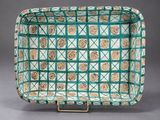 a green and white tray with a pattern on it