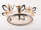 a silver tray with a silver tea set on it