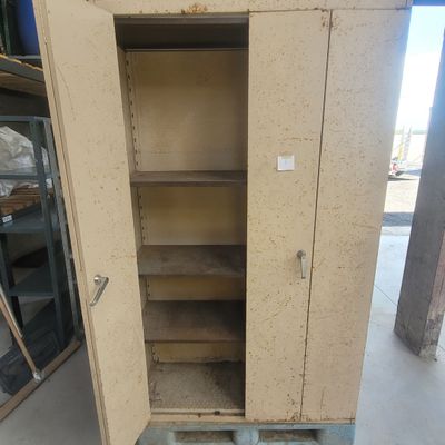 a cabinet that has a door open in a warehouse