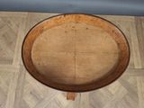 a wooden table with a wooden top on a tile floor