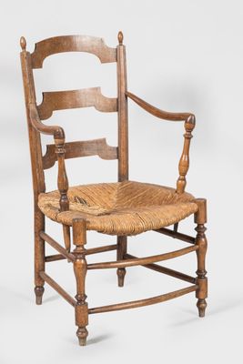 an old wooden chair with a woven seat on a white background