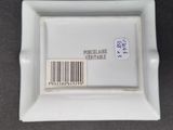 a small white plate with a barcode on it