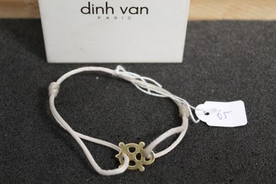 a bracelet that has a gold anchor on it