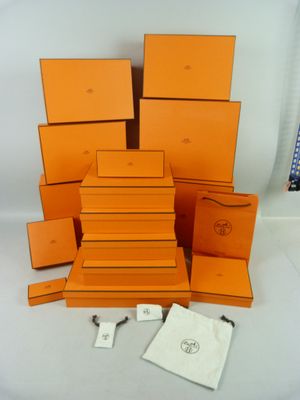 an image of a pile of orange boxes sitting on top of a white table