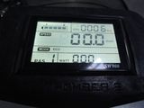 a close up of a digital clock on the back of a motorcycle