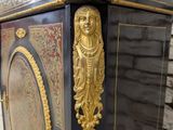 a black and gold clock with a gold face on it