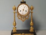 a clock that is sitting on a table next to a pair of scissors