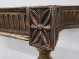 a close up of a metal table with a flower decoration on it