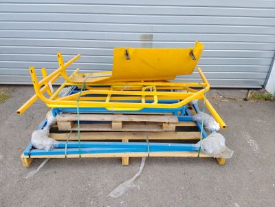 une palette sur laquelle est posé un siège jaune, devant un garage