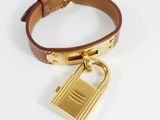 a close up of a bracelet with a padlock on a white surface