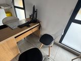 a desk and chair in a room with a large window