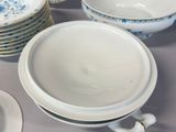 a lot of plates and bowls on the table