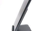 a cell phone on a stand on a white surface