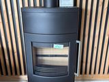 a black stove sitting in the corner of a room