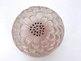 a pink glass bowl with a flower design on it