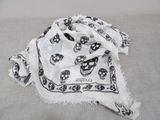 skull and crossbones on a white scarf on a bed