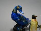 three figurines of birds that are sitting next to each other