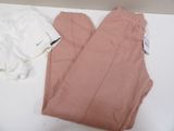 a pair of pink pants and a white shirt on a table