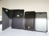 three cell phones are sitting next to each other on a table