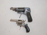 two revolvers that are sitting on a table