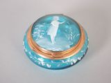 une boîte bleue et dorée sur laquelle figure l'image d'une femme