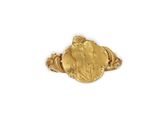 a close up of a gold ring with a woman ' s face on it
