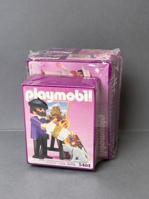 a box of playmobil with a picture of a man and a woman