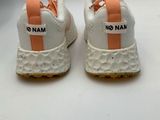 white and orange sneakers with no name on them on a white surface