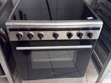 a stove and oven in a kitchen with tile flooring