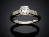 a close up of a diamond ring on a black surface