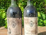 two bottles of wine sitting on a wooden table