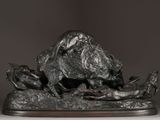 a bronze sculpture of a dog and a cat on a table