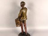 bronze figurine of a man with a briefcase on a marble base