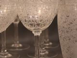 a lot of wine glasses that are sitting on a table
